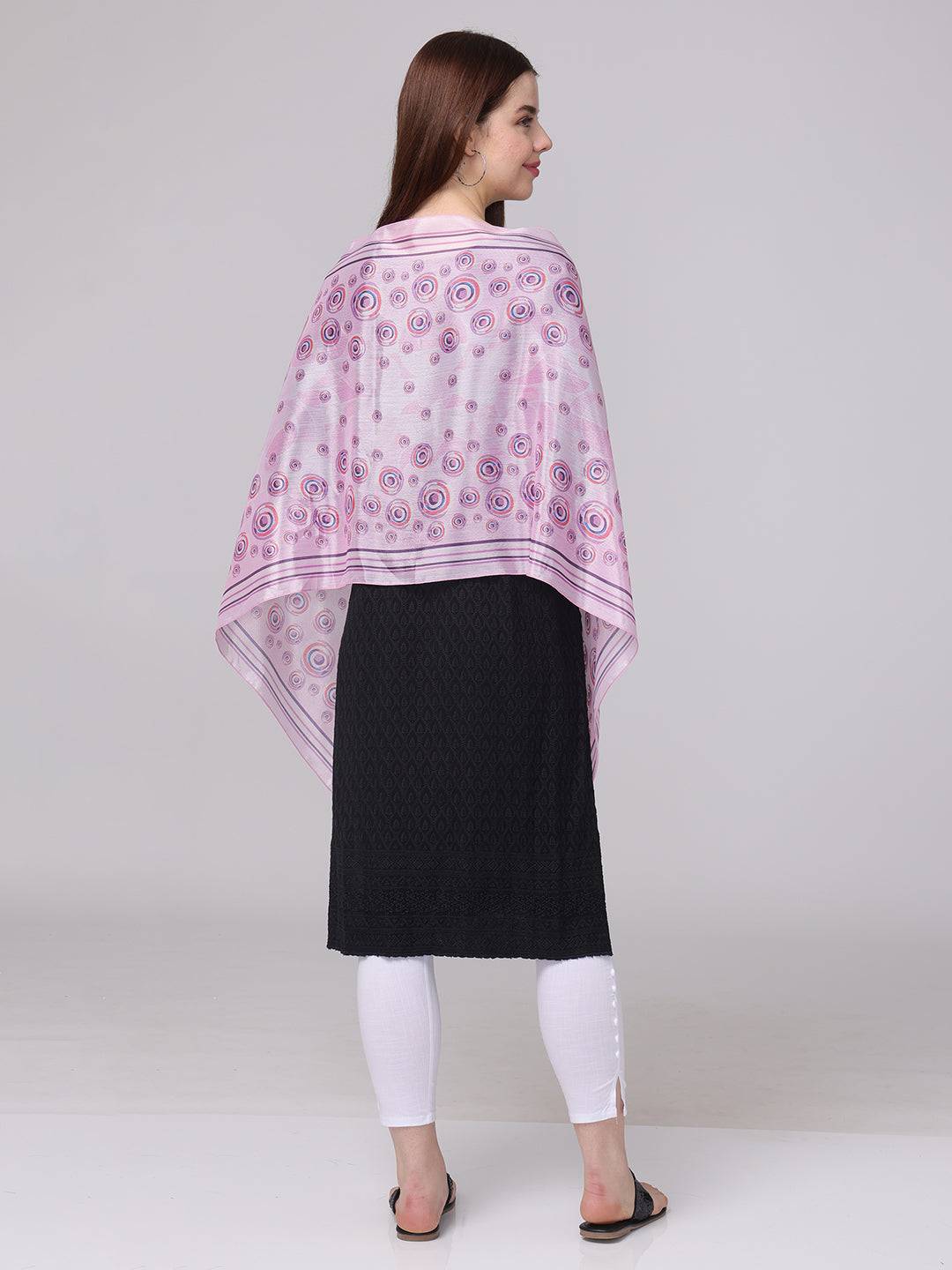 Back view of vibrant circular printed scarf in pink and purple.