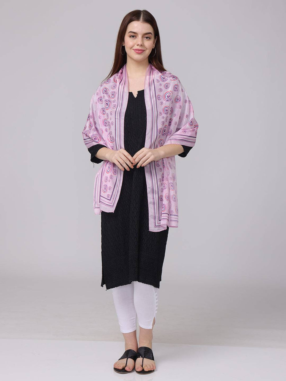 Front view of vibrant circular printed scarf draped over shoulders.