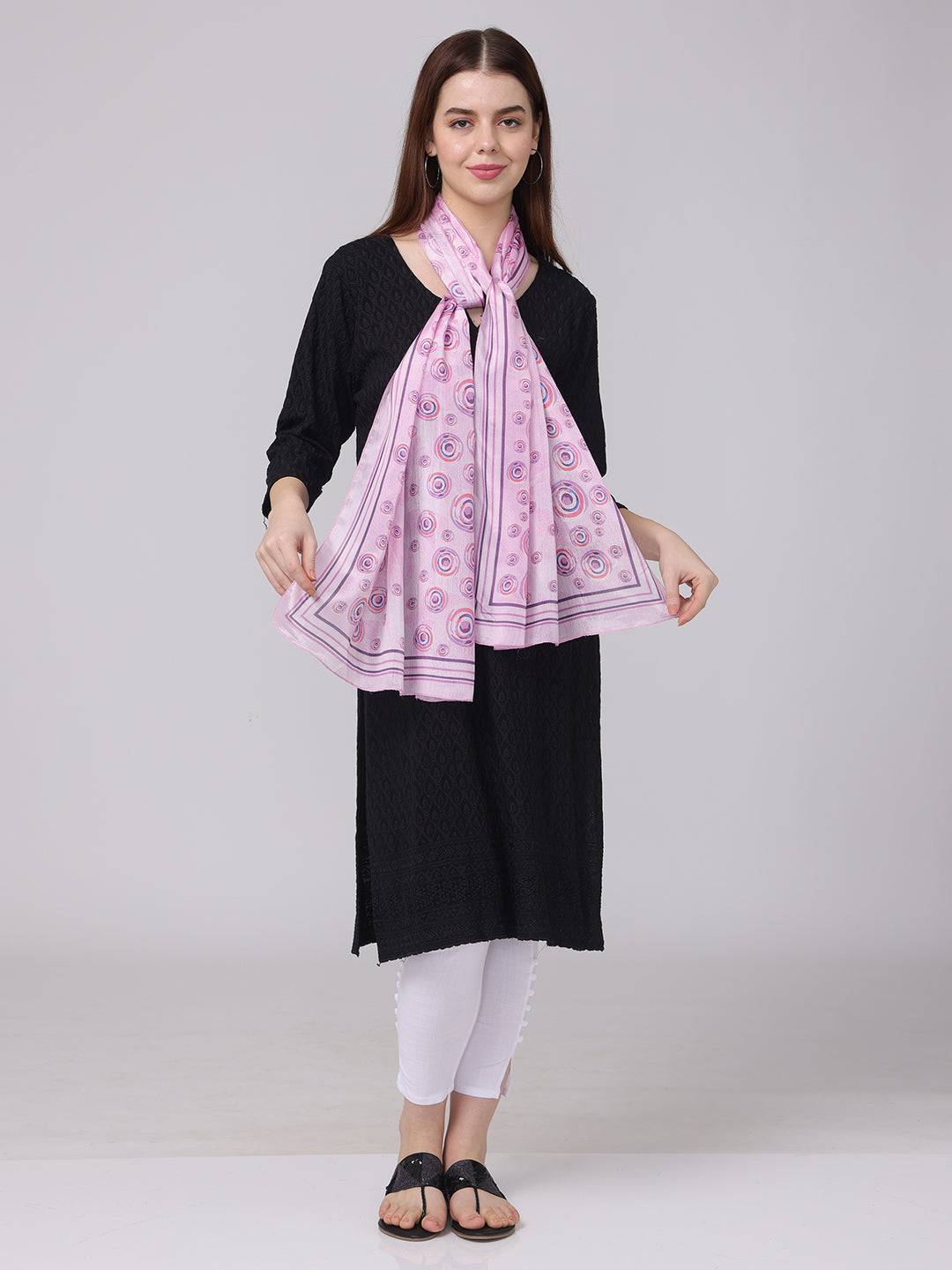 Vibrant circular printed scarf in pink and purple, front view.