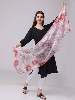 Model holding floral and geometric print scarf