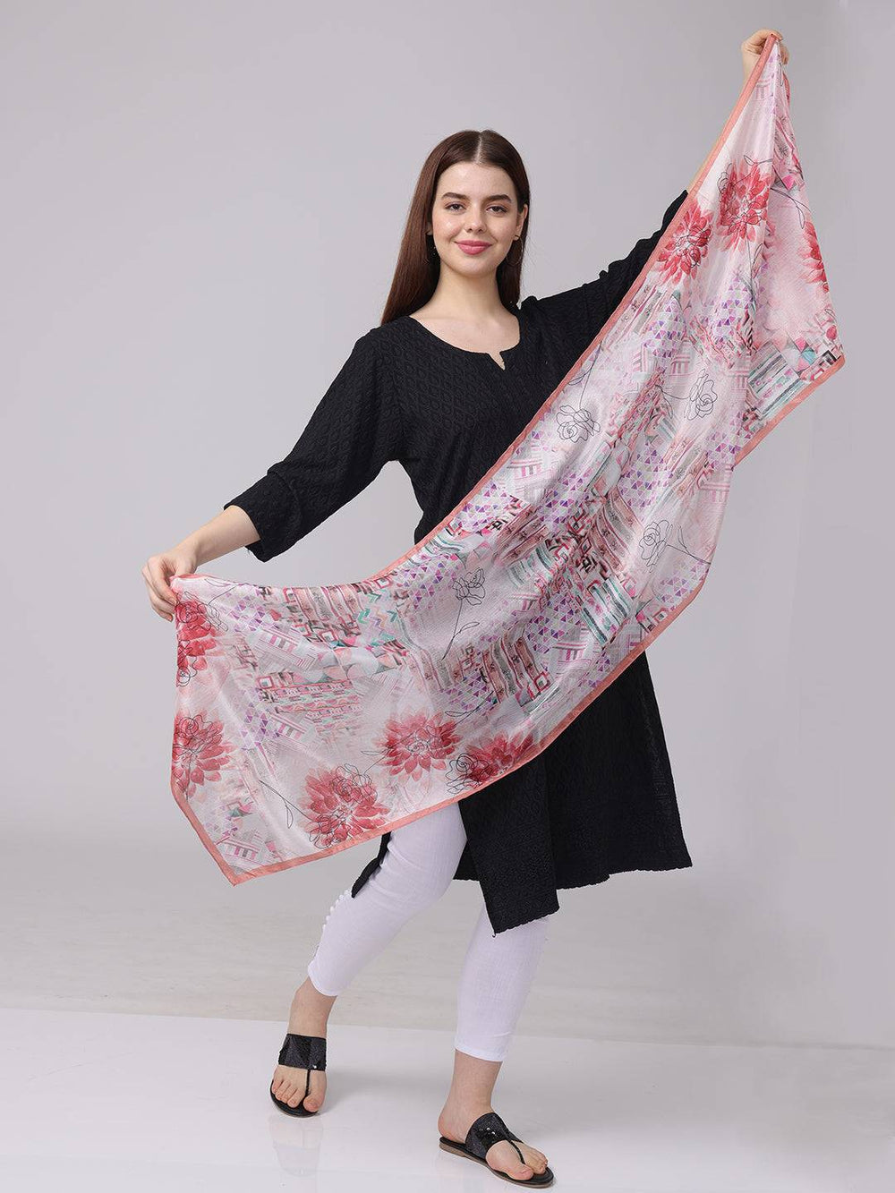 Model holding floral and geometric print scarf