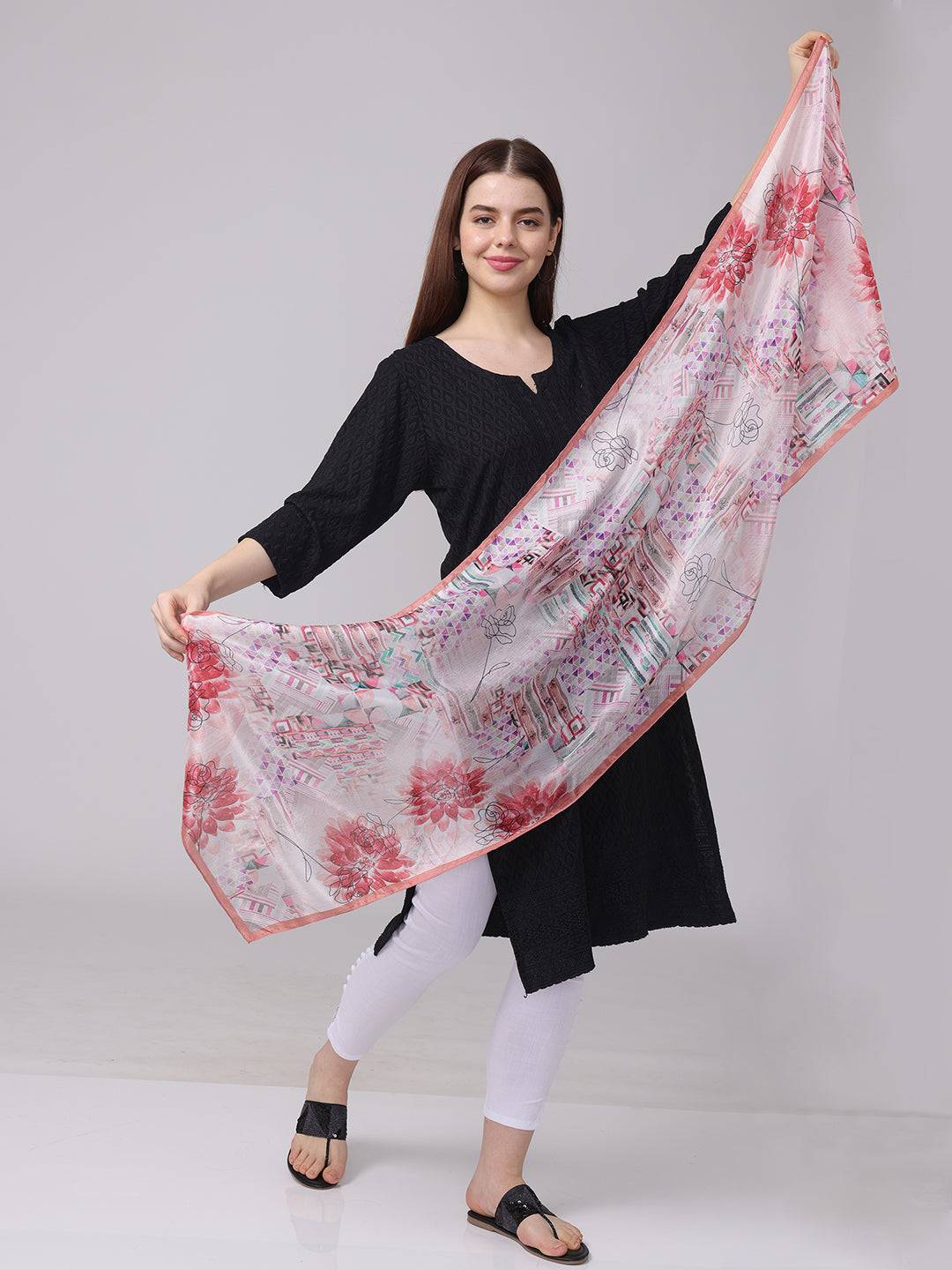 Model holding floral and geometric print scarf