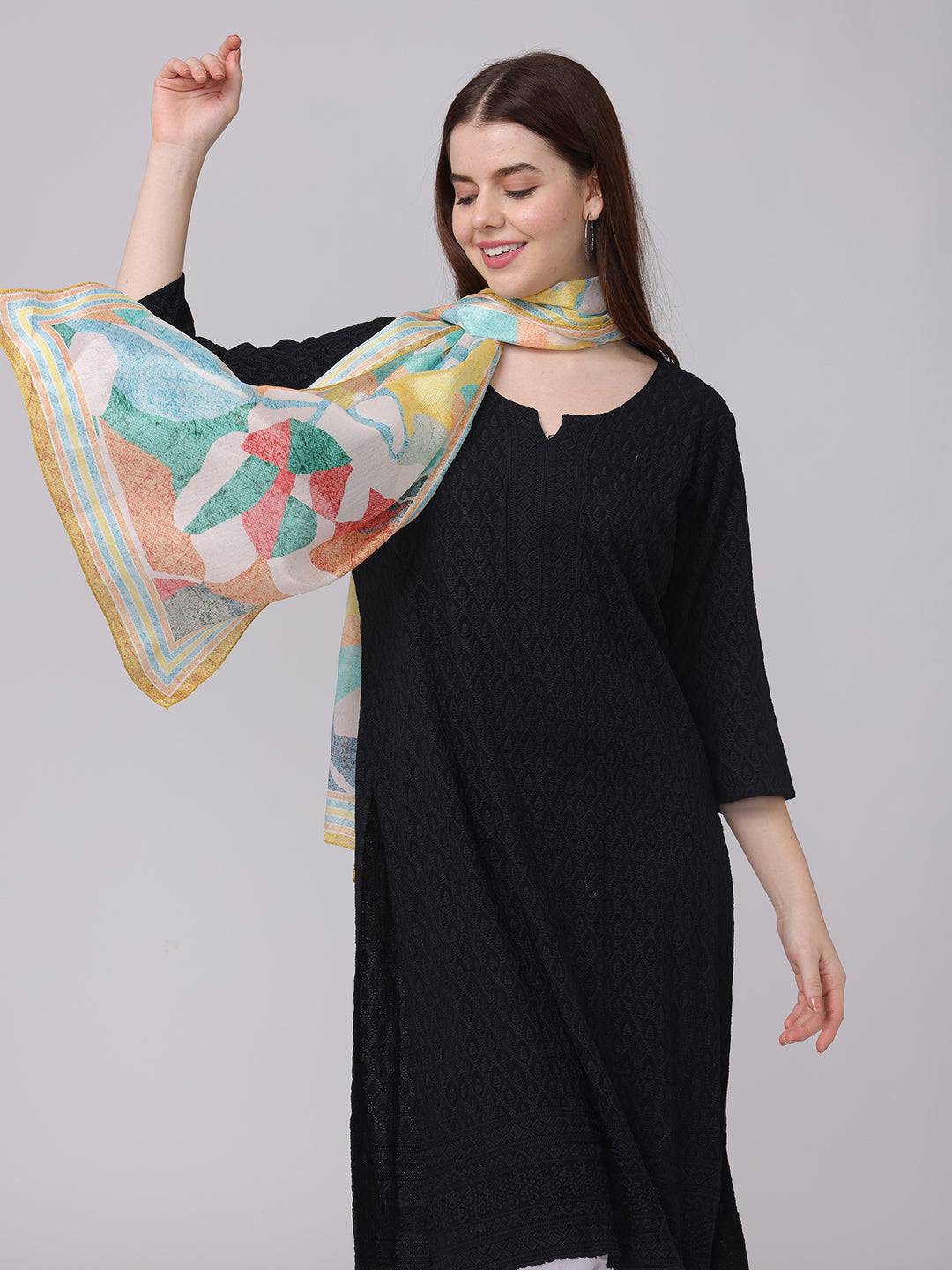 Colorful abstract design scarf draped over shoulder.