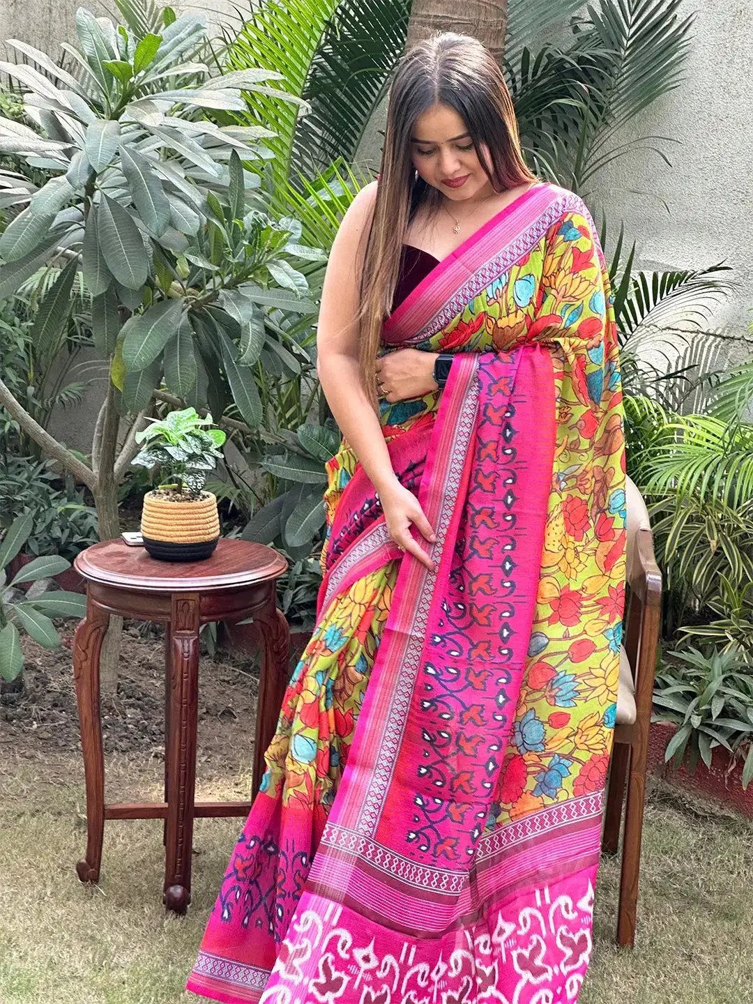 Floral Ikkat saree with pink border, outdoor pose