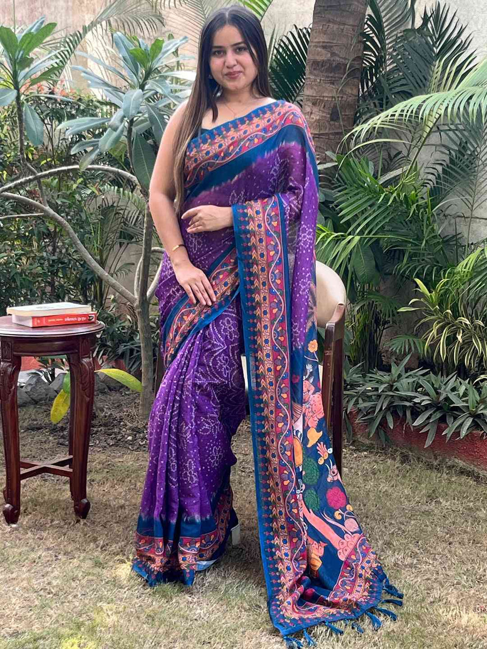 Model wearing purple Bandhej Kalamkari saree, outdoor scene