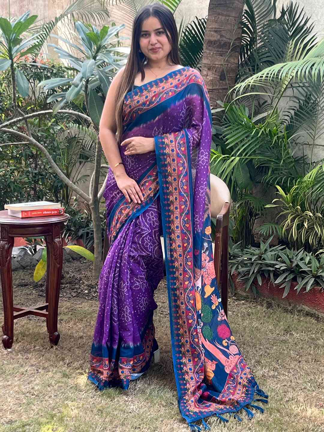 Model wearing purple Bandhej Kalamkari saree, outdoor scene