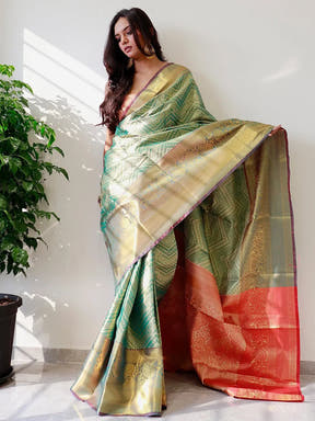 Elegant gold zari Kanjivaaram silk saree draped on model.
