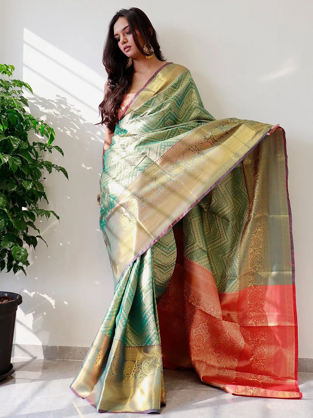 Elegant gold zari Kanjivaaram silk saree draped on model.