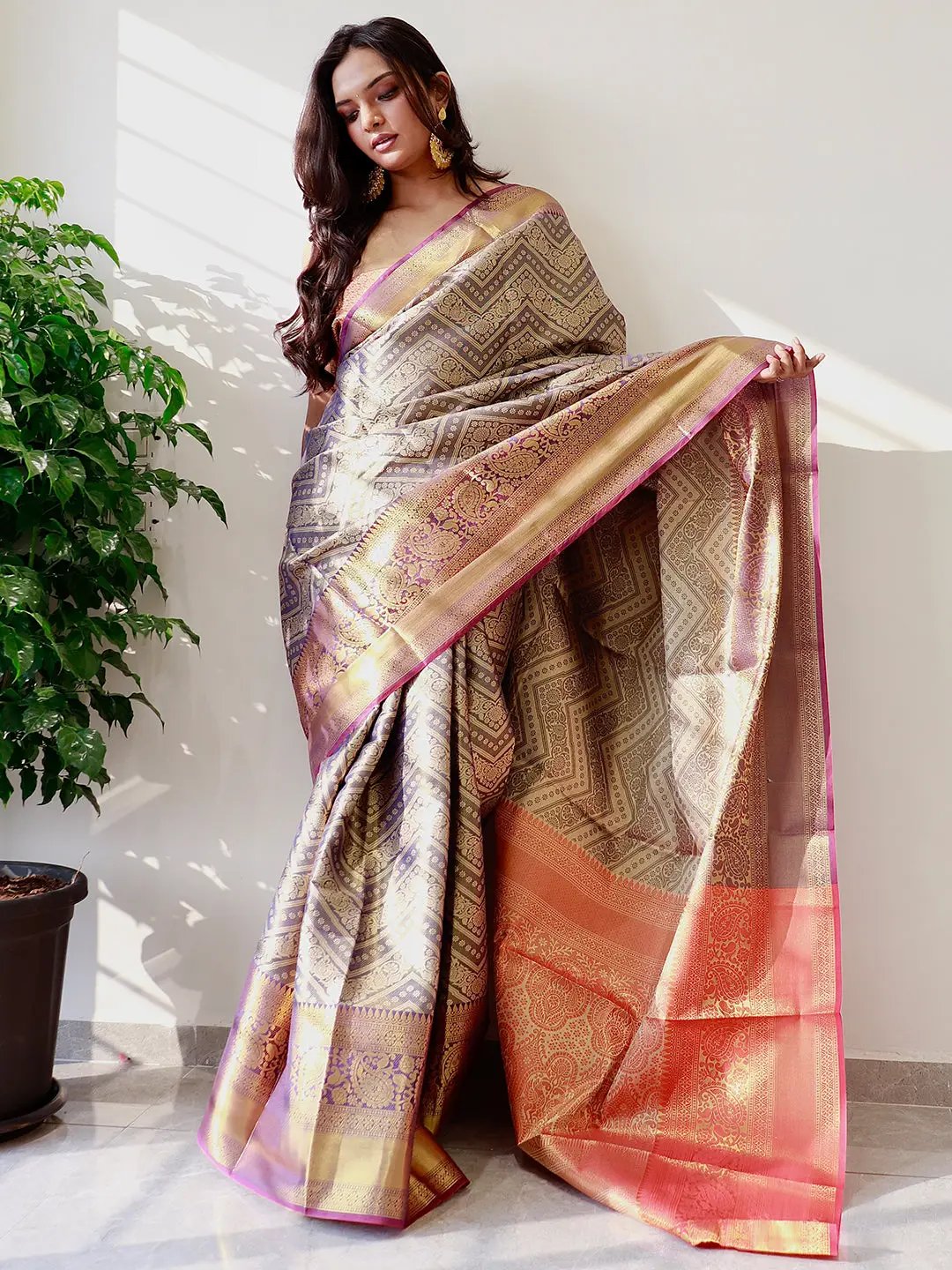 Elegant gold zari Kanjivaaram pattu silk saree draped gracefully.