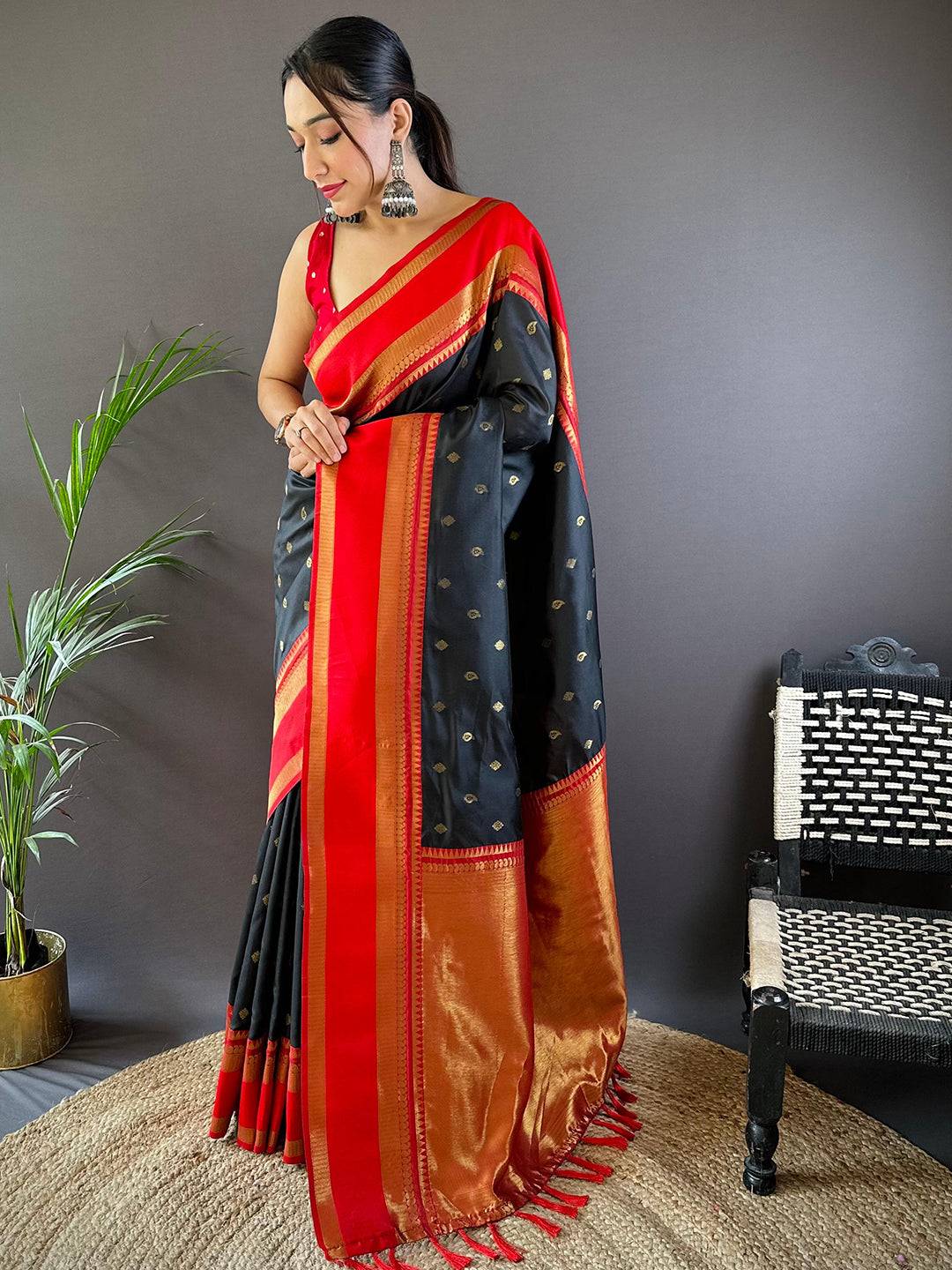 Model showcasing black Banarasi saree with intricate gold zari