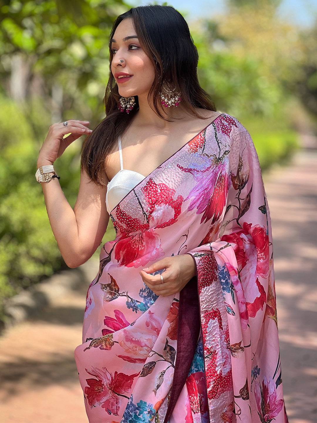 Model wearing satin georgette peach floral saree outdoors
