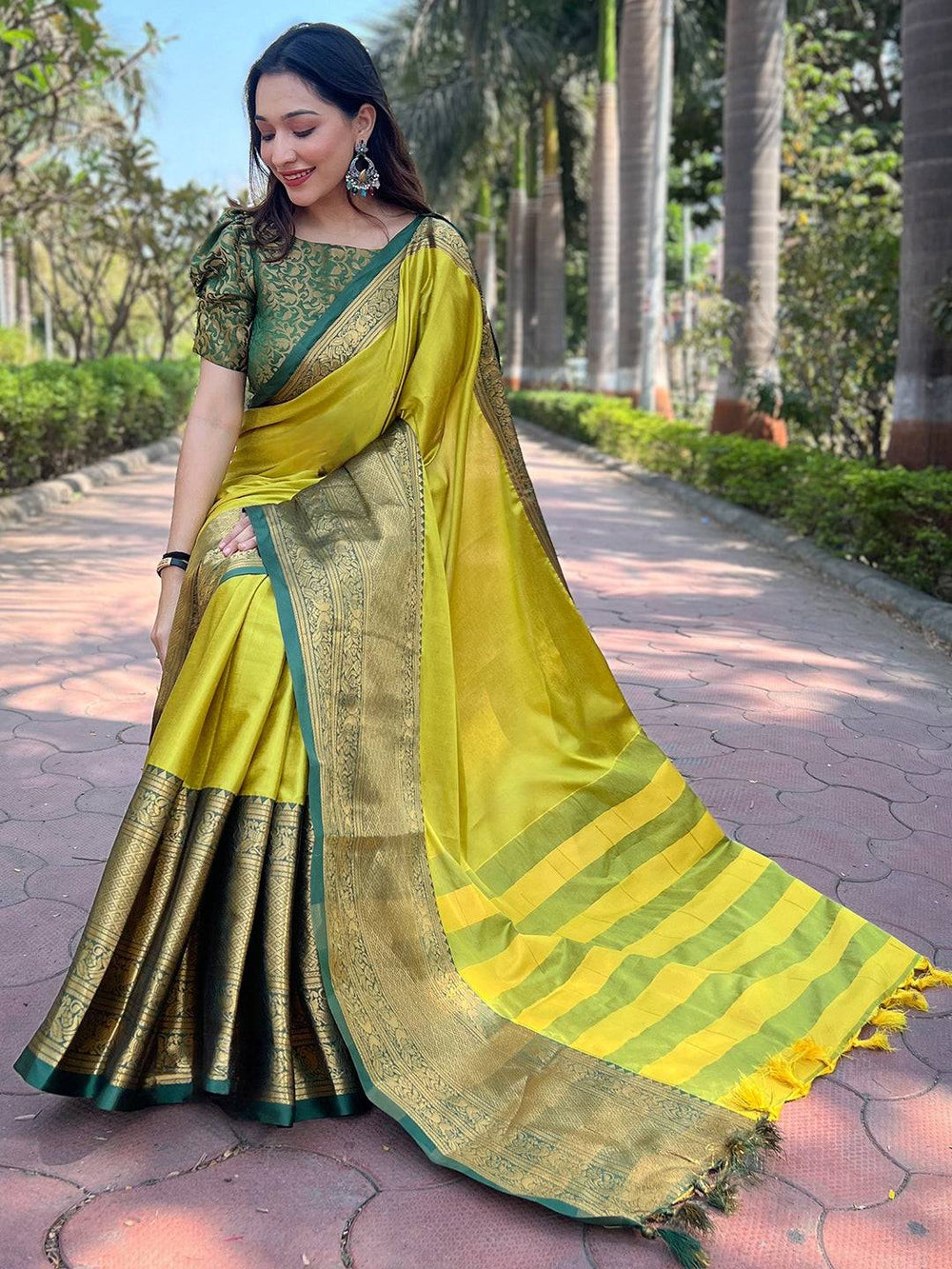 Model showcasing light green Kanjivaram saree with rich texture