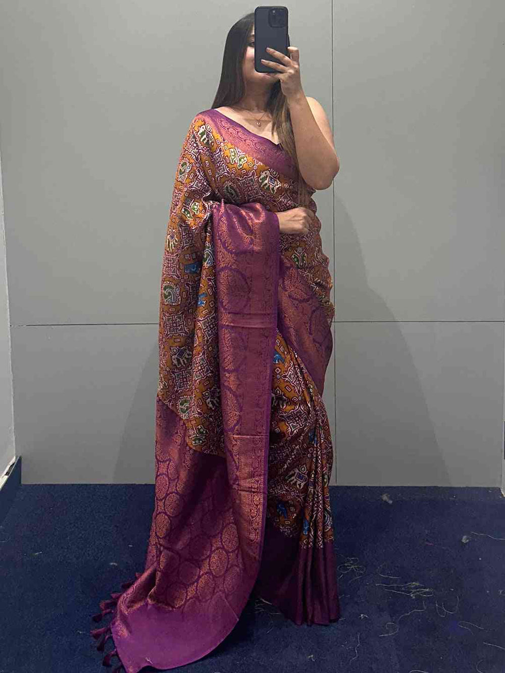 Purple Patola saree with intricate designs on display