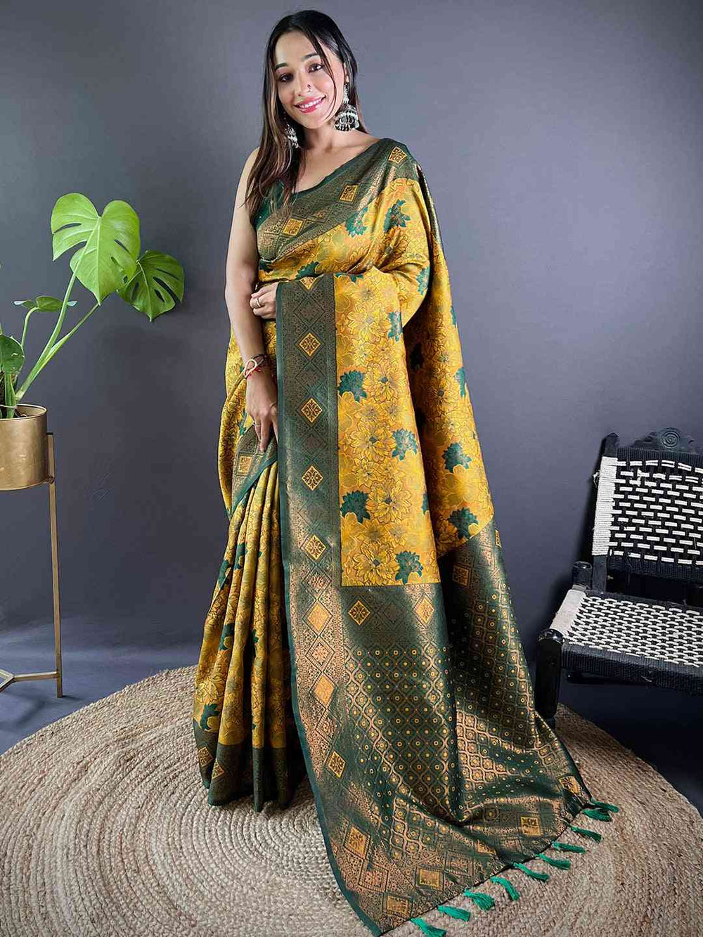 Model showcasing mustard silk saree with intricate butta design.