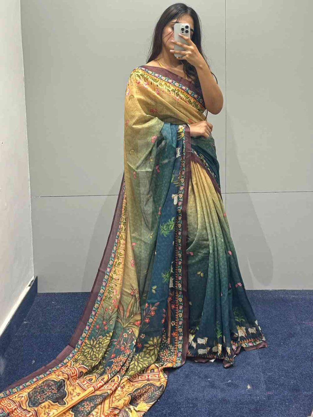 Turquoise Pichwai Print Saree displayed in fitting room.