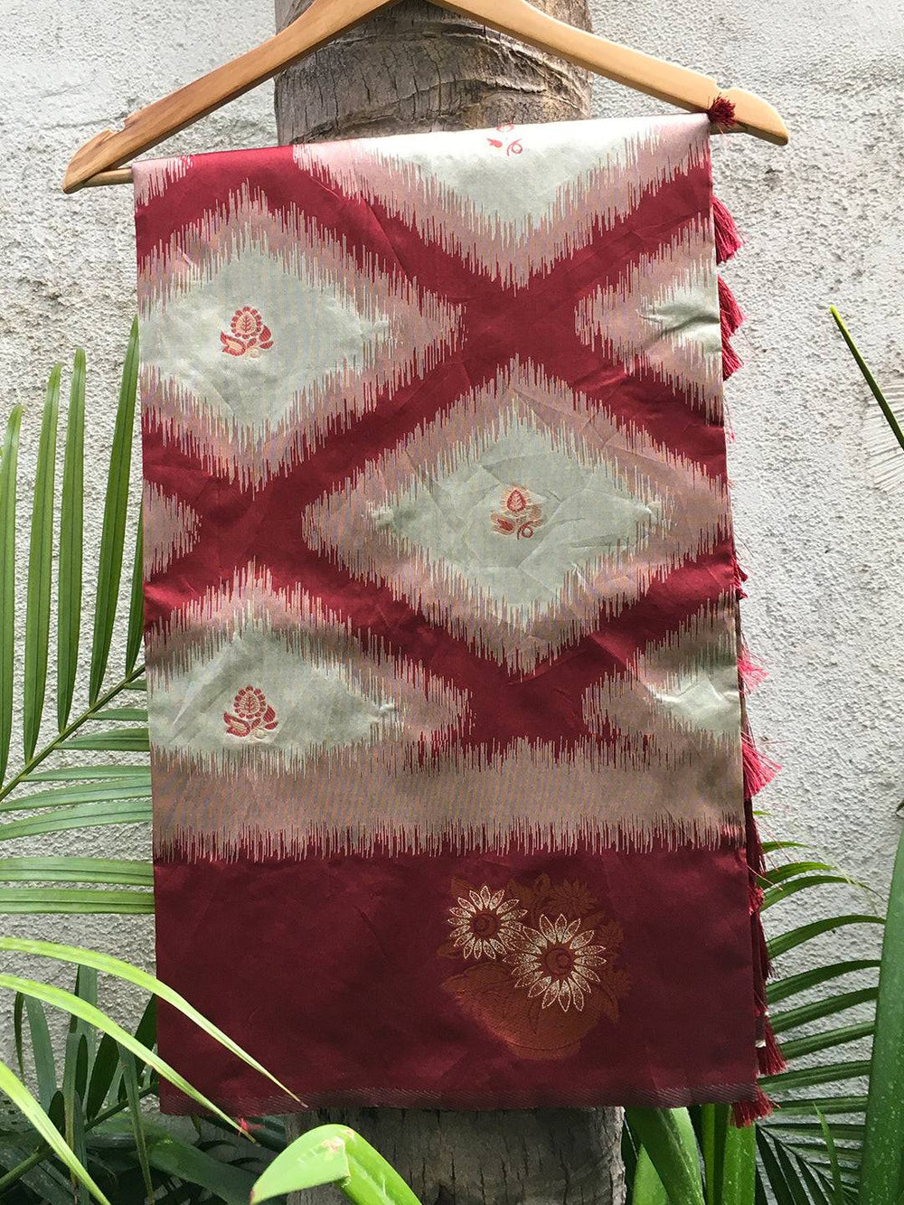 Maroon Tussar Silk Saree draped on hanger showcasing Ikkat design