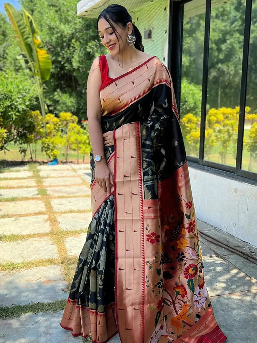 Model showcasing black Paithani silk Pichwai saree with floral design