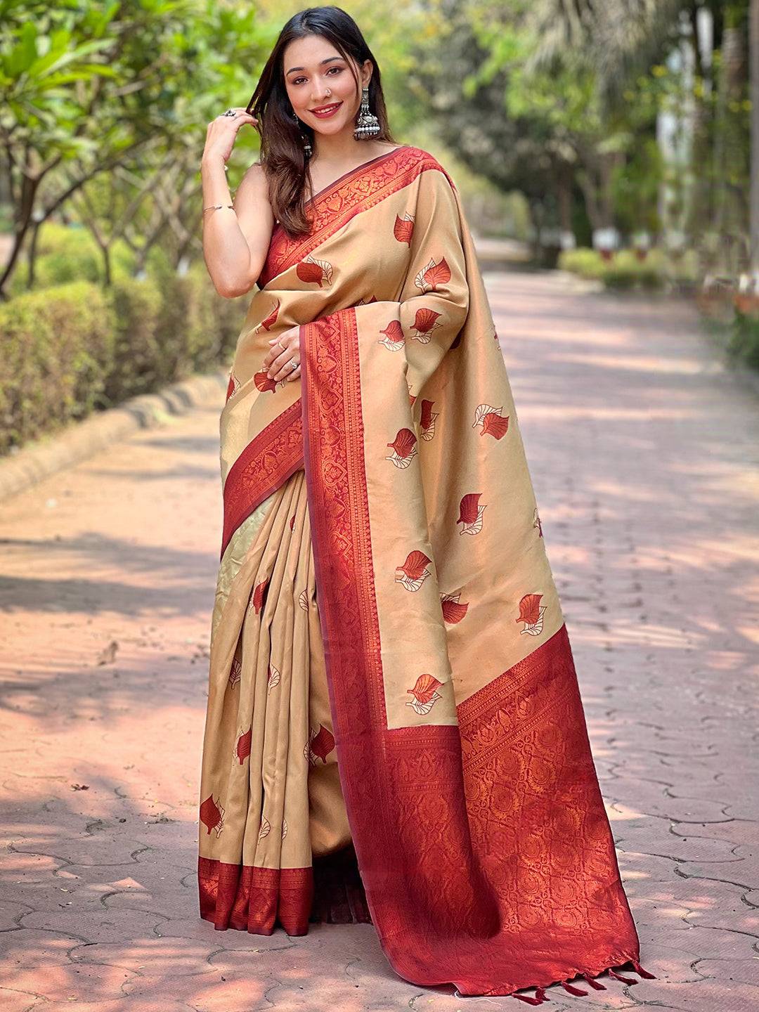Full view of beige saree with red border and leaf designs