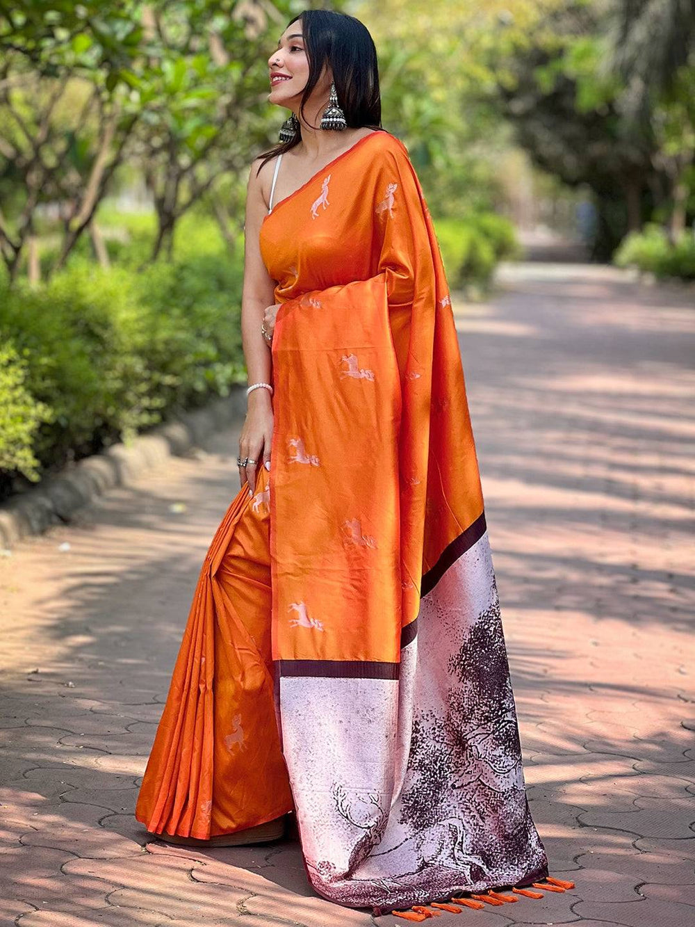 Side view of orange soft silk saree with intricate pallu