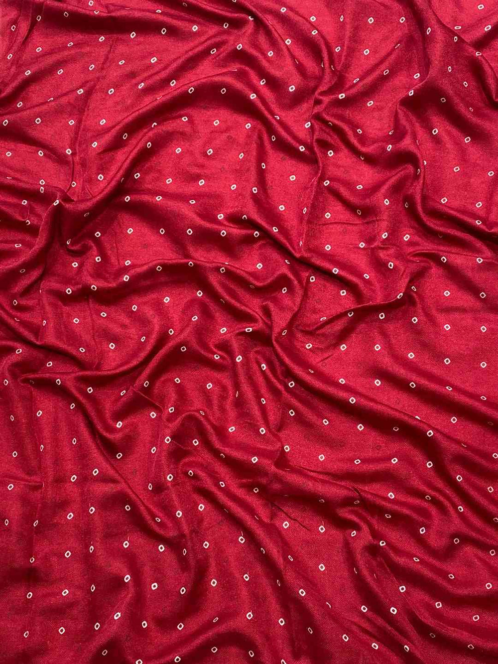 Close-up of red Manipuri silk fabric with small foil prints