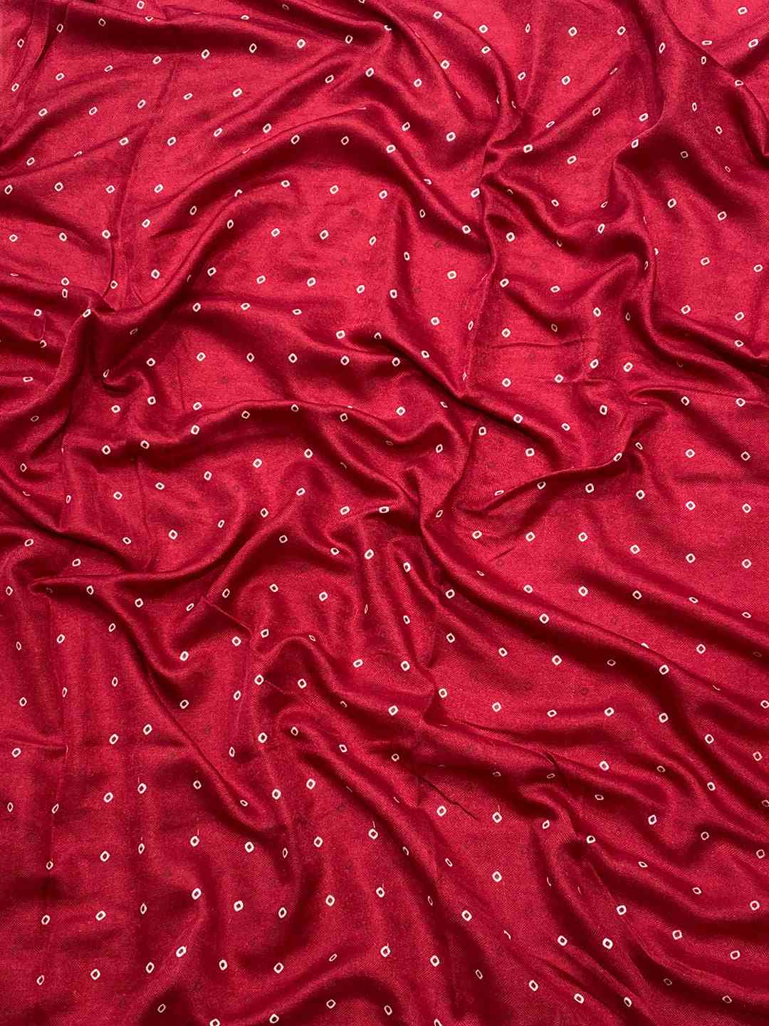 Close-up of red Manipuri silk fabric with small foil prints