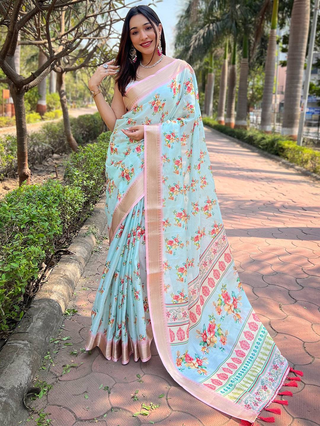 Turquoise Kota saree with digital floral print, worn by a model.