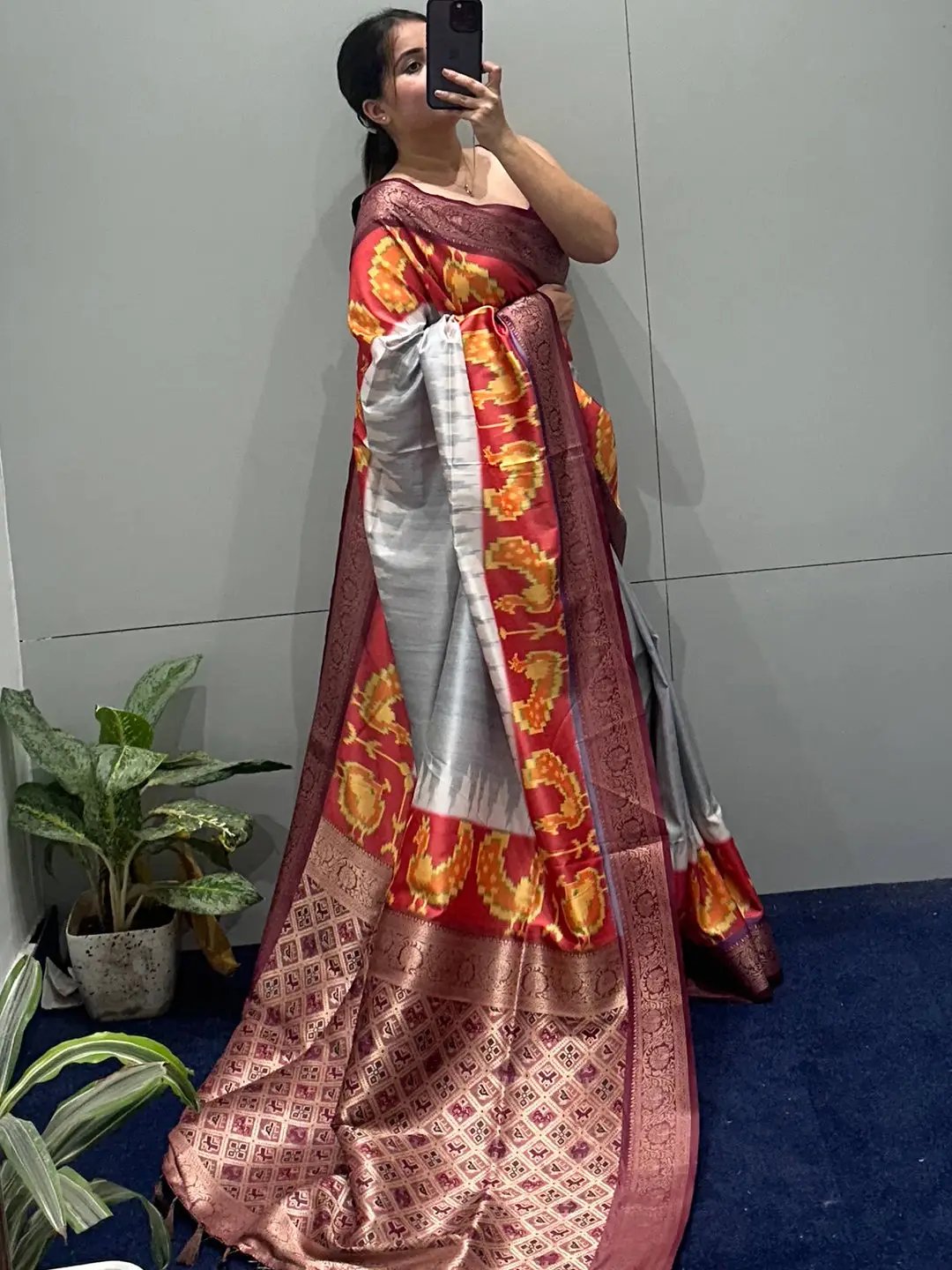 Banarasi soft silk saree with vibrant zari patola pallu in indoor setting