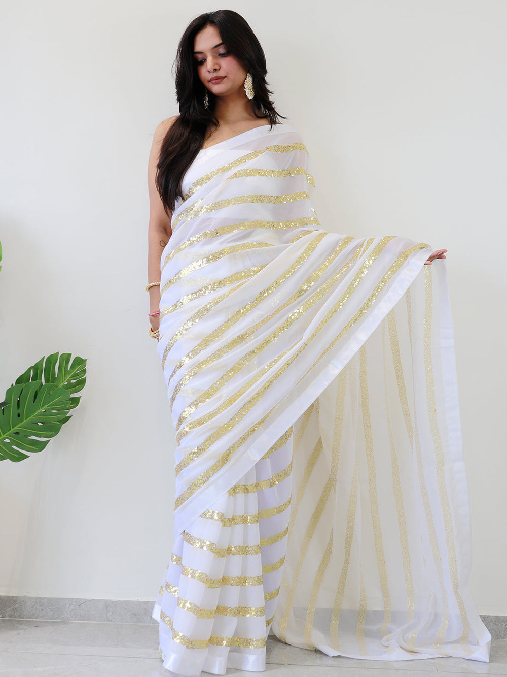 Elegant georgette saree featuring gold sequins stripes
