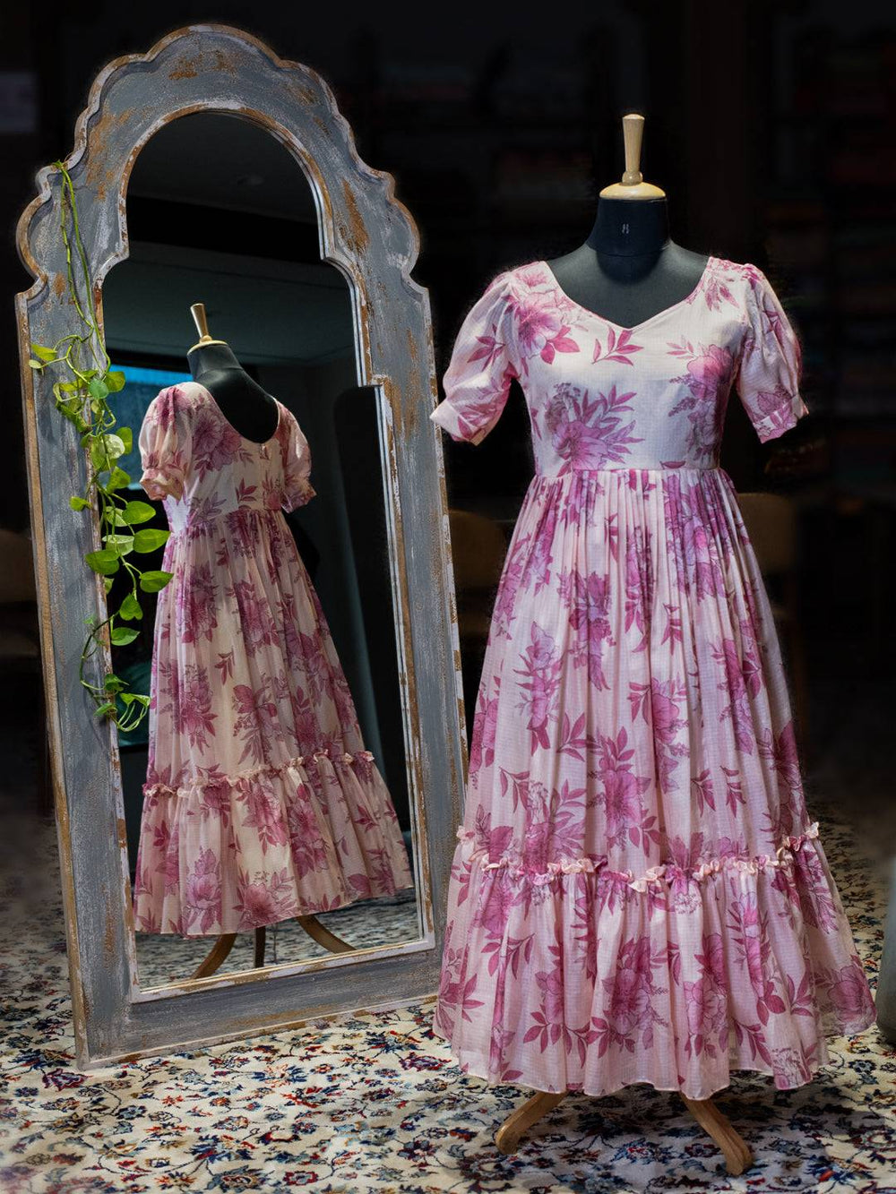Pink midi dress on mannequin with floral print and puff sleeves
