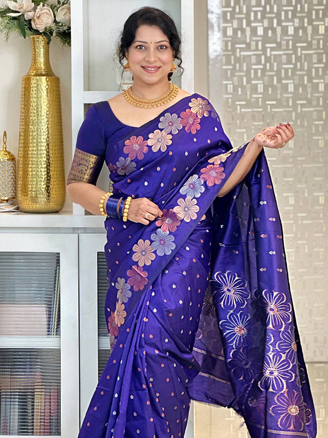 Woman in purple silk saree with floral zari design
