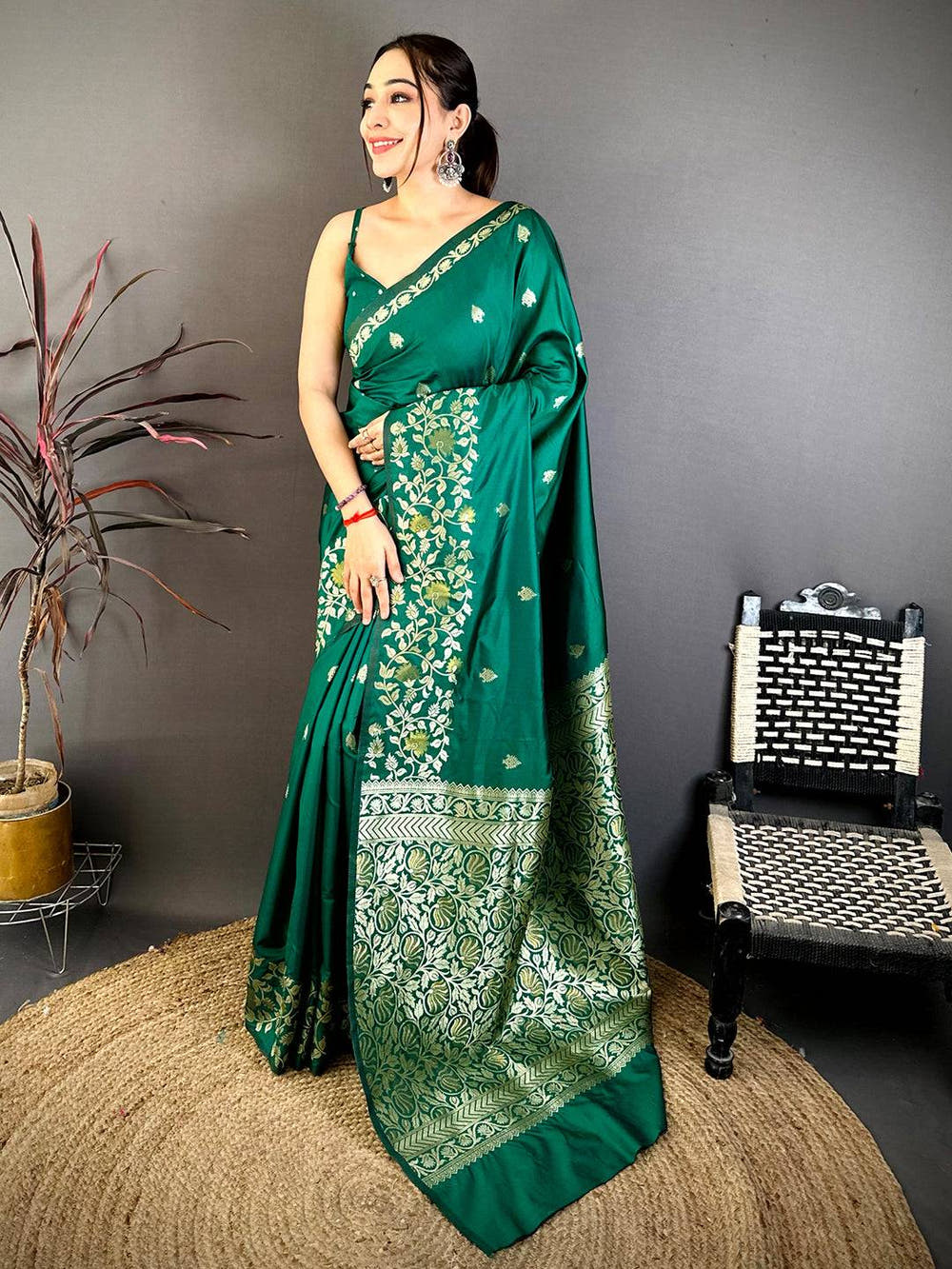 Elegant emerald green silk saree with gold floral motifs and detailed border