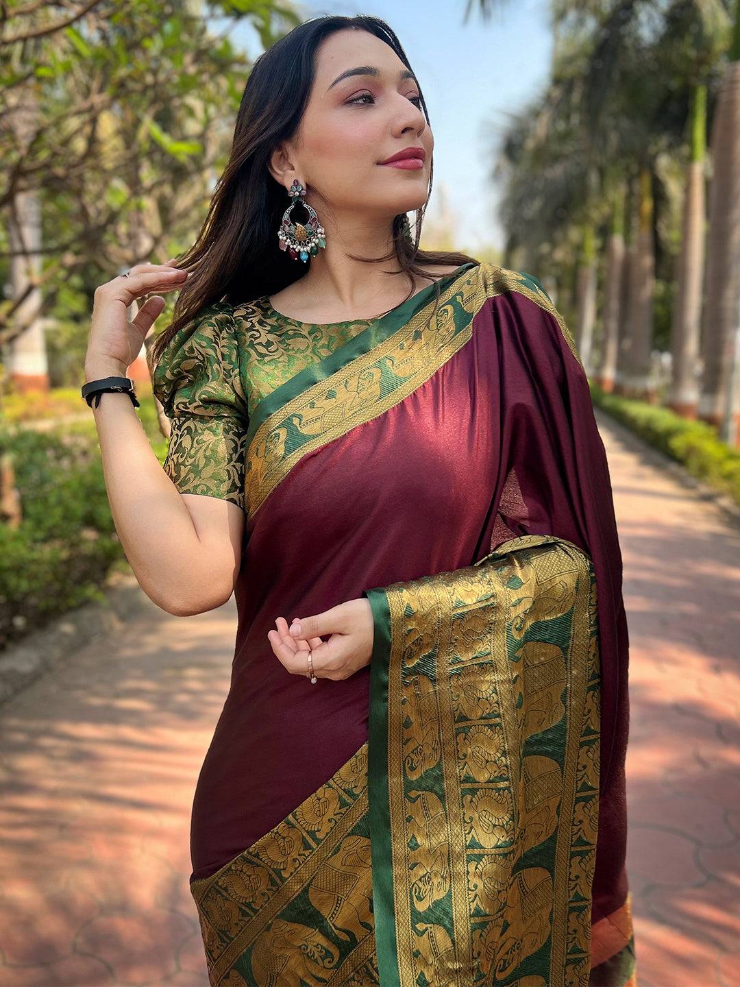 Wine color Kanjivaram saree with gold border, outdoor setting