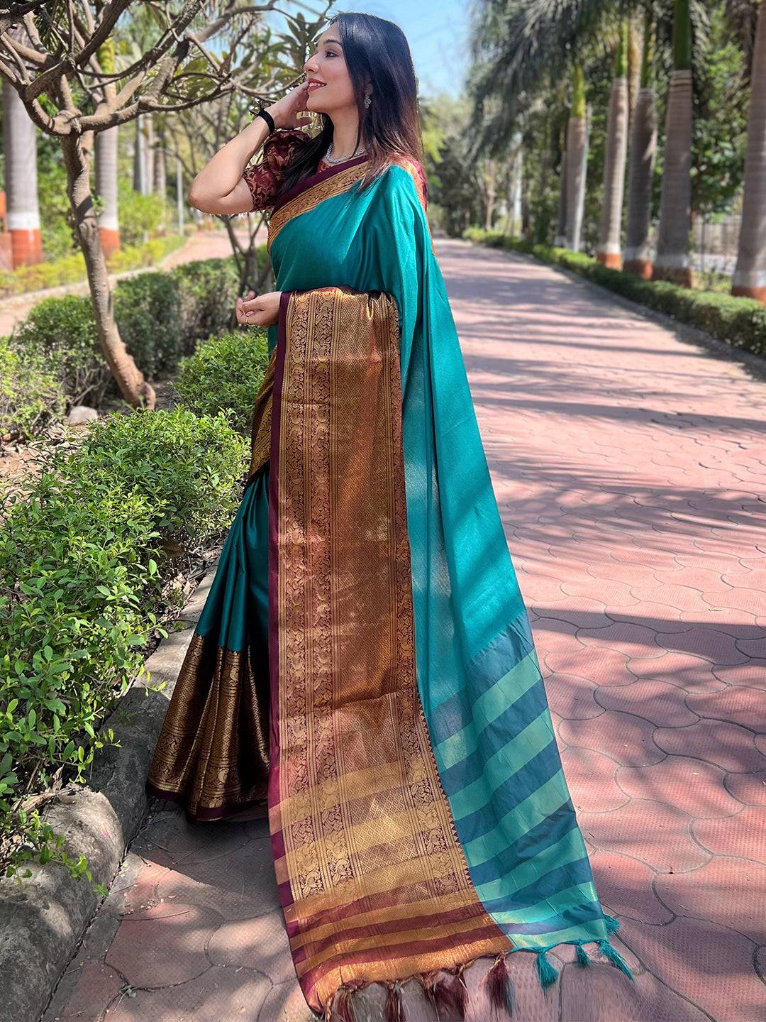 Elegant teal saree with gold weaving and detailed border