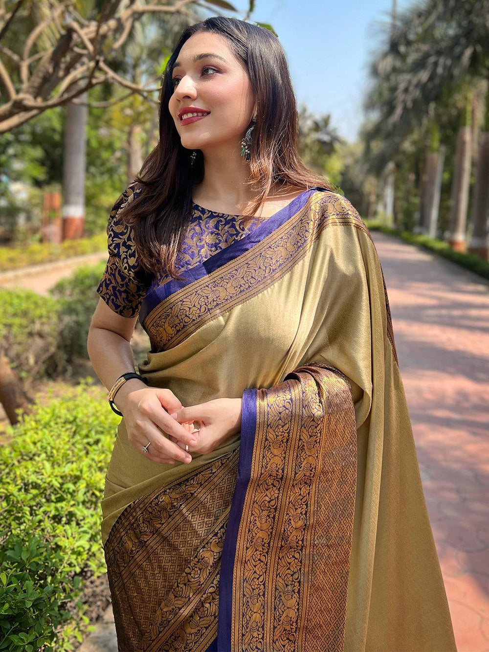 Woman in olive Kanjivaram saree with intricate weaving