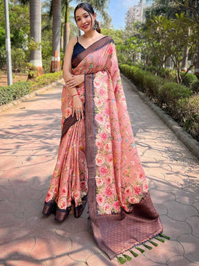 Peach silk saree with copper zari floral design, outdoor setting