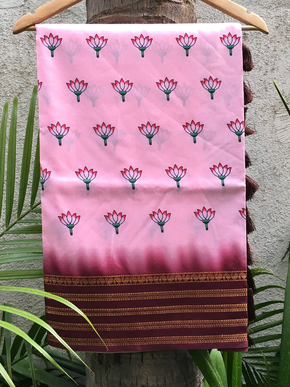 Pink 2 Ton Lotus Print Silk Saree hanging on a hanger