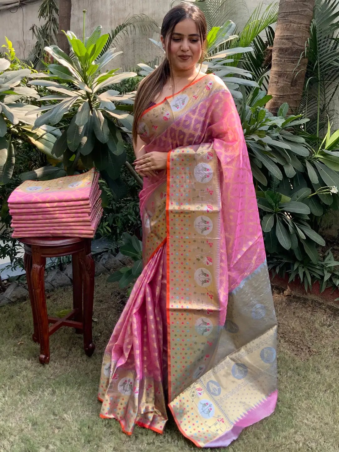 Model showcasing pink Kota Doria silk saree with intricate design
