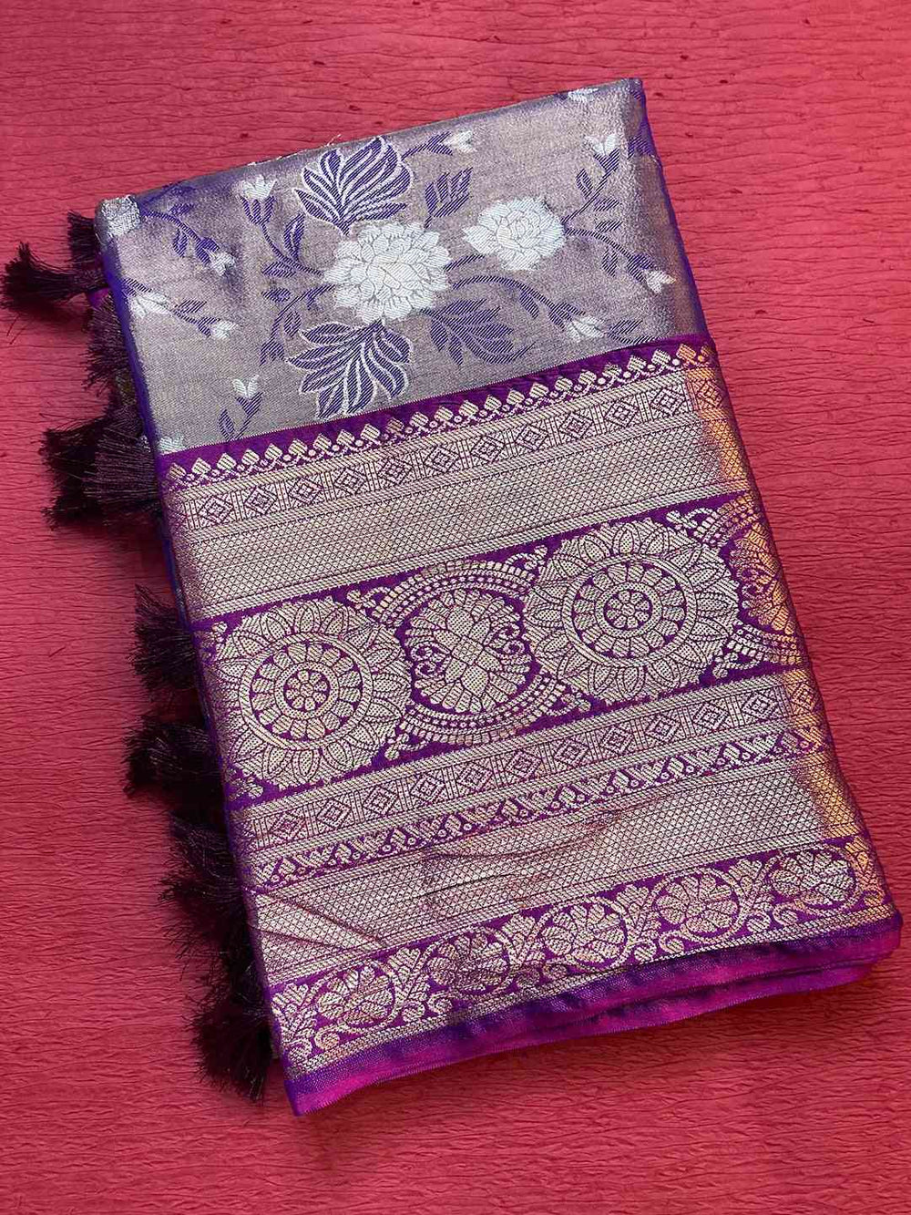 Folded purple tissue silk saree with floral design