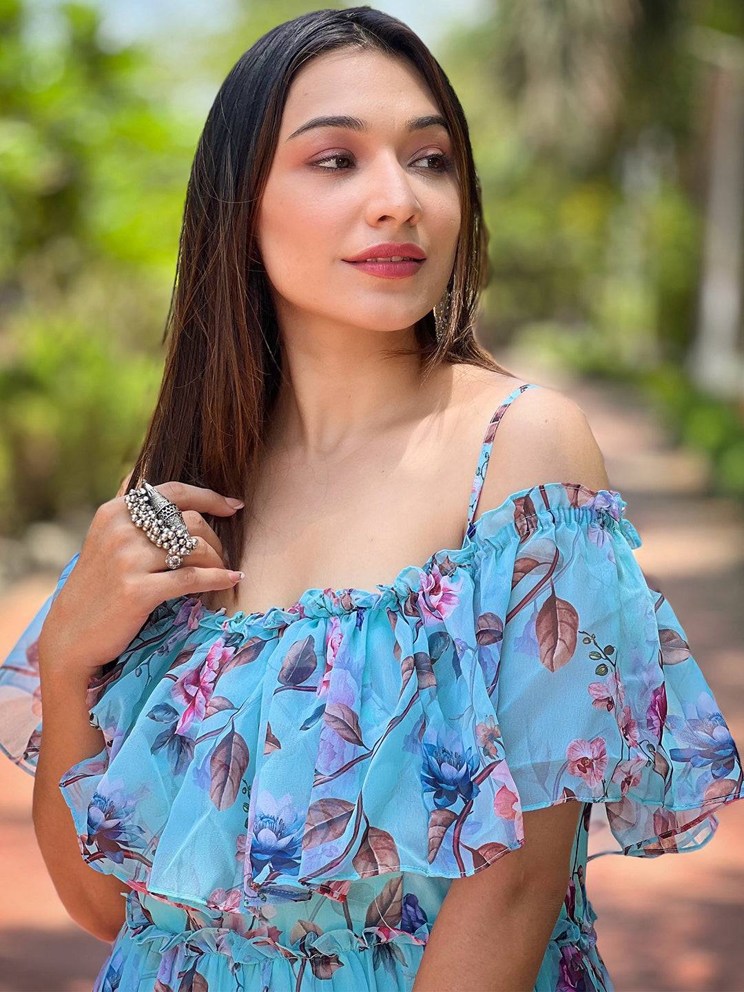 Close-up of woman in blue floral maxi dress