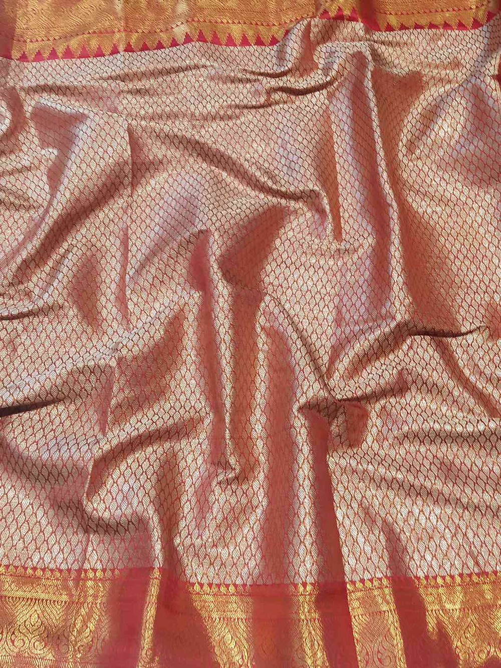 Detailed view of jacquard woven pattern on gold tissue saree