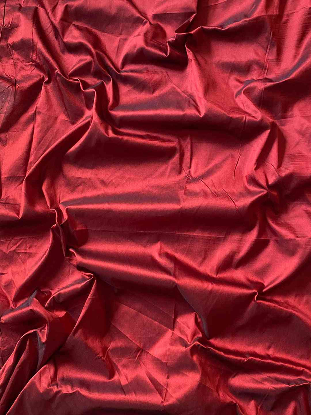Red blouse piece fabric for teal Paithani saree.