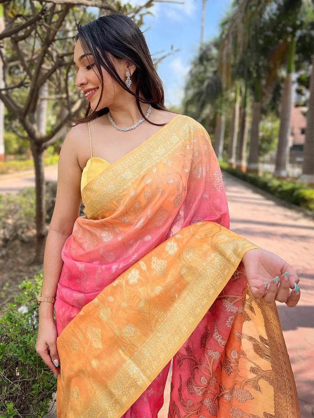 Close-up of pink slub silk saree with zari and Lakhnavi badla weaving