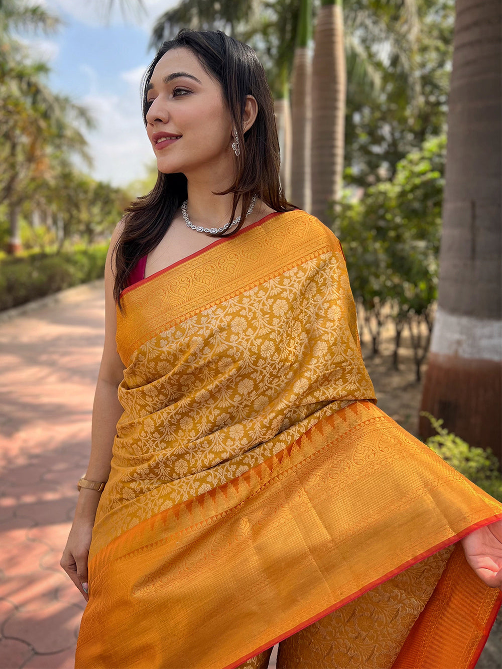 Close-up of yellow gold tissue saree with jacquard woven details