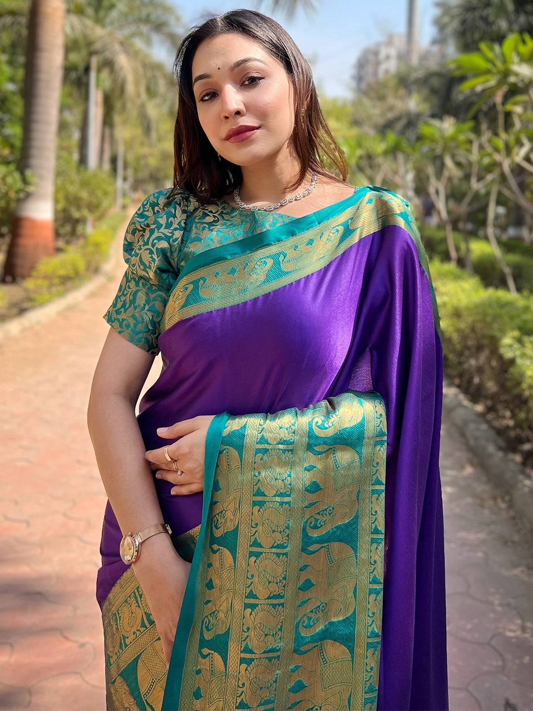 Woman in indigo Kanjivaram saree with gold border