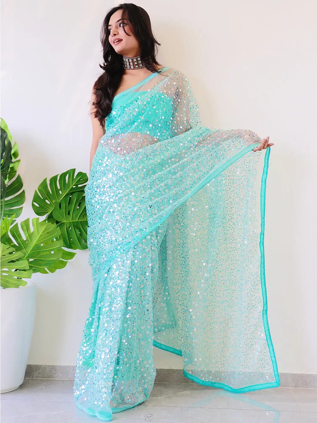 Model showcasing net saree with shimmering sequins work