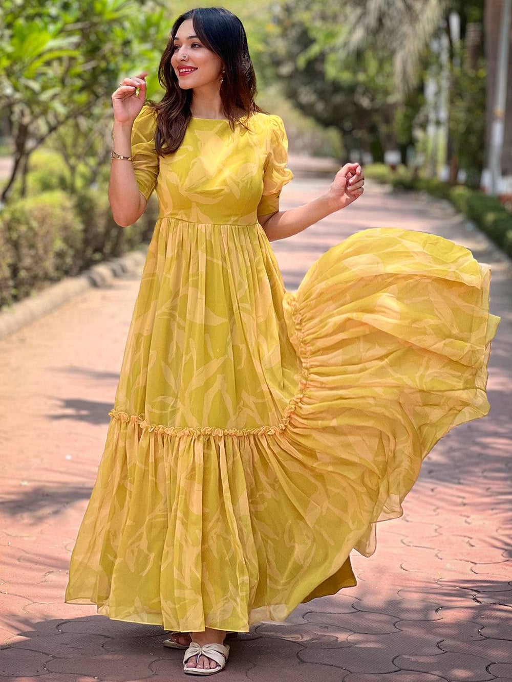 Model twirling in lime yellow abstract print dress