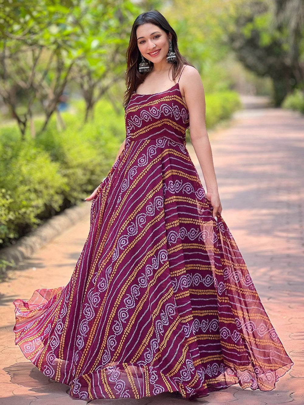 Model posing in Wine Bandhej Printed Dress in garden