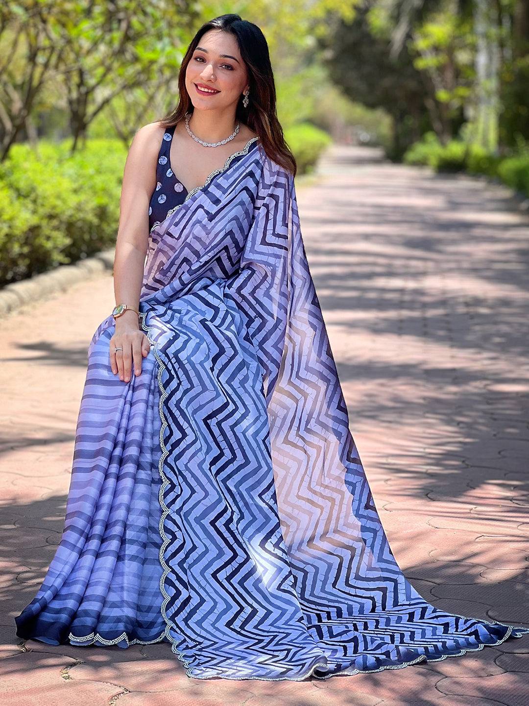 Sitting pose with Leheriya and striped print saree