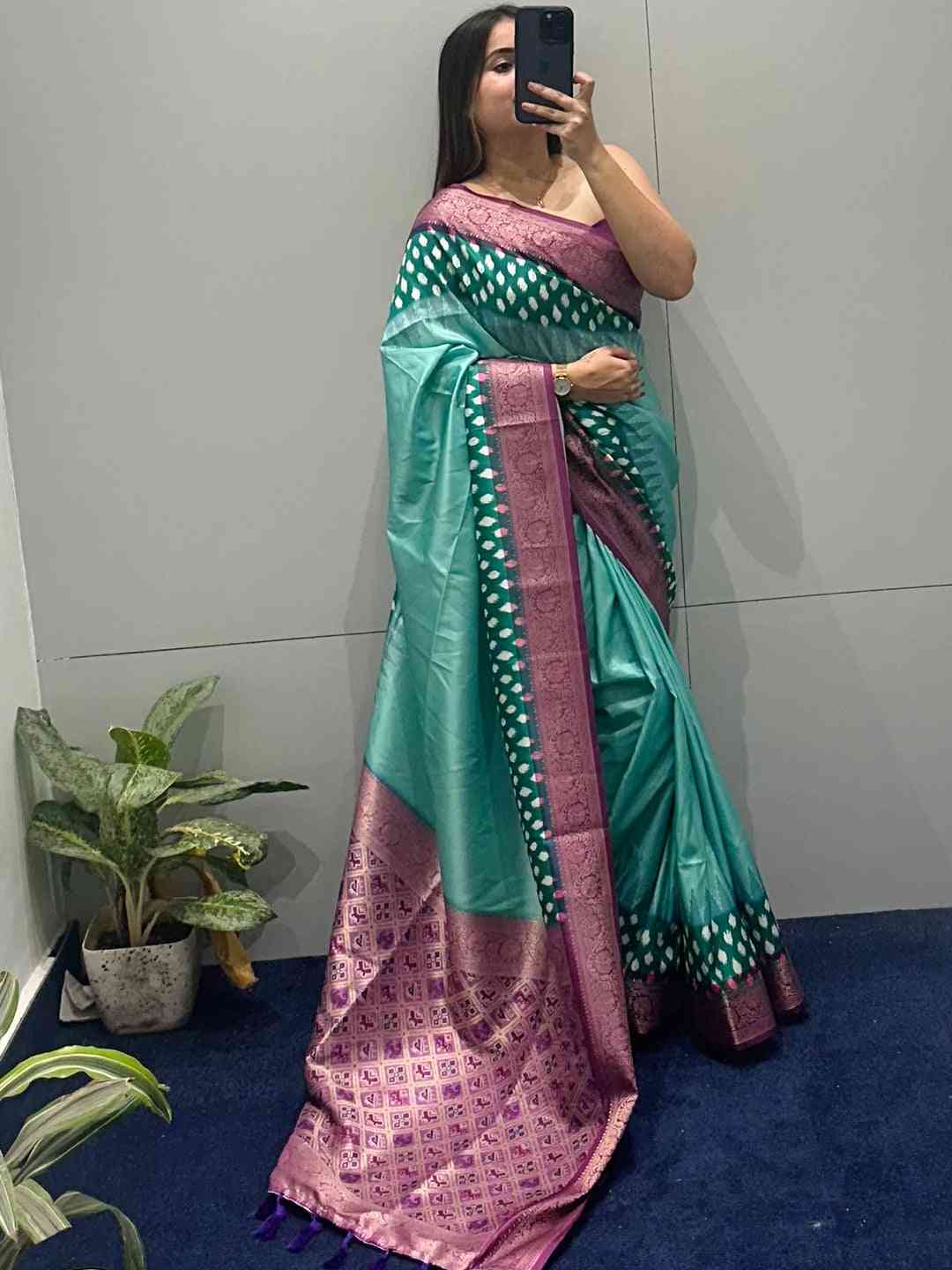 Modern Banarasi soft silk saree with exquisite Patola pallu indoors.