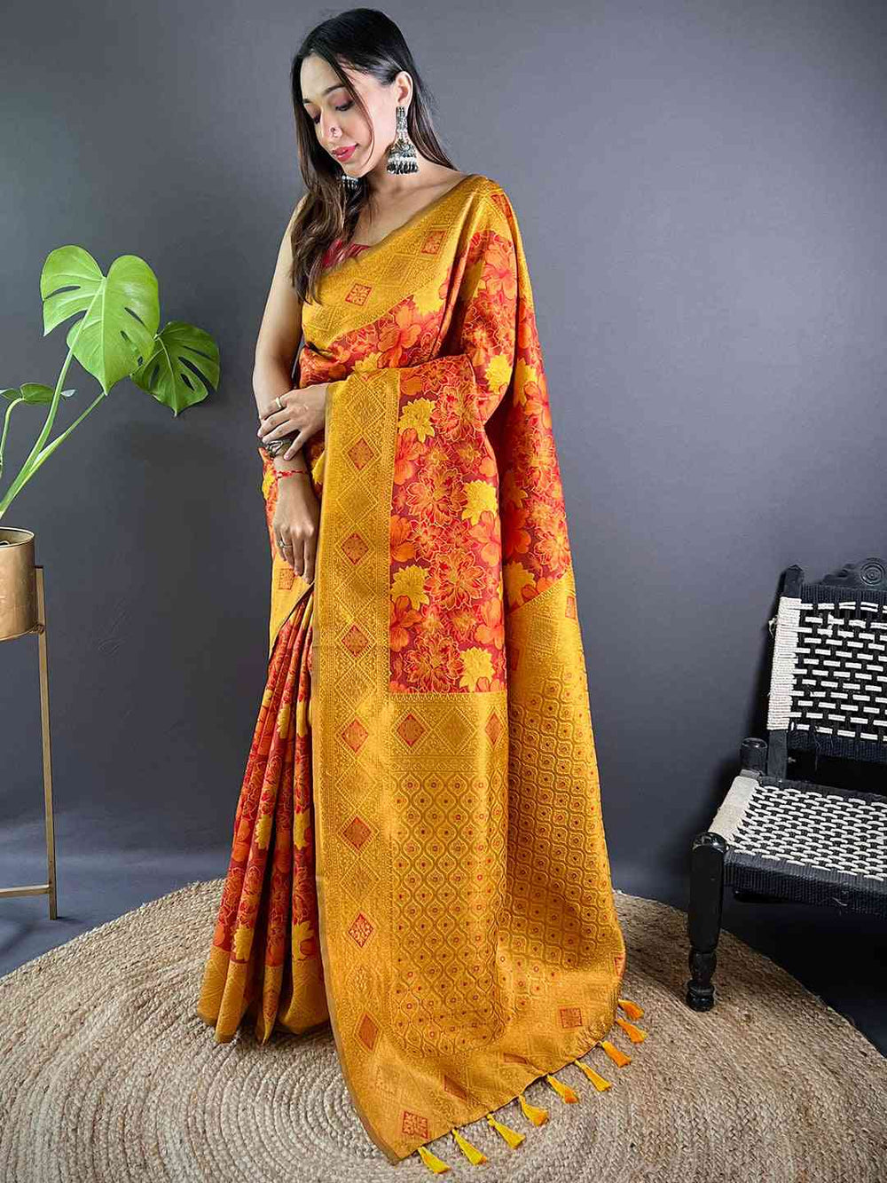 Model showcasing rust silk saree with elegant floral patterns